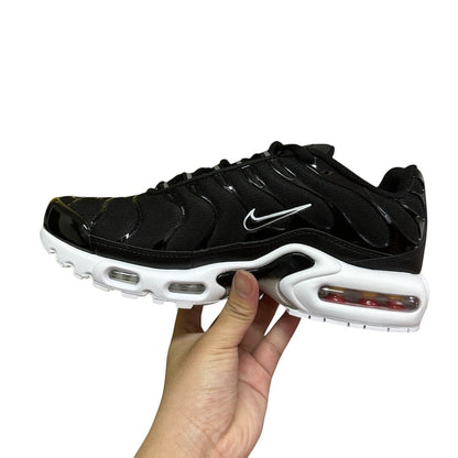 Luxury Chef black Nike TN sneakers with white accents and visible air cushioning. Mesh and patent leather details.