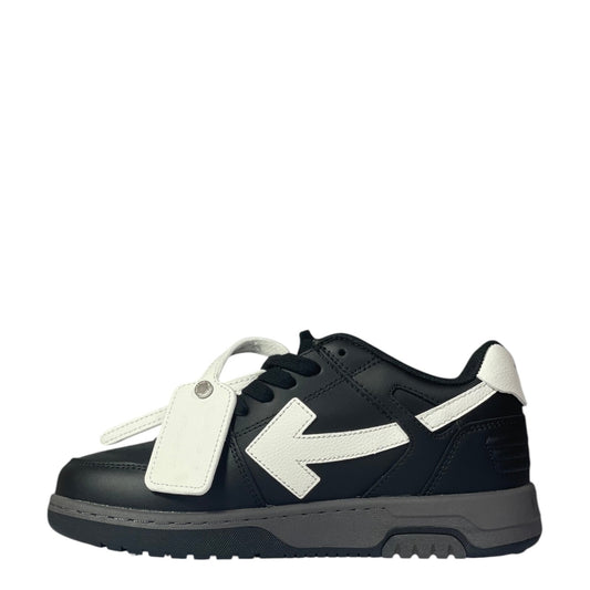 Luxury Chef black leather low-top sneakers with white arrow logo and tag. Grey sole.