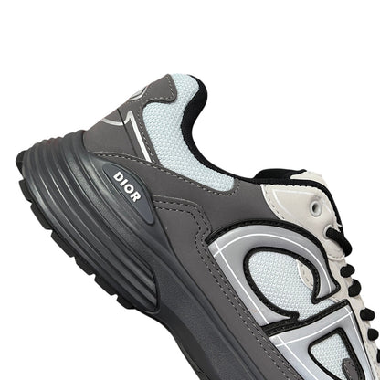 Luxury Chef DIOR B30 grey and white mesh and leather sneakers with black laces and a thick sole.