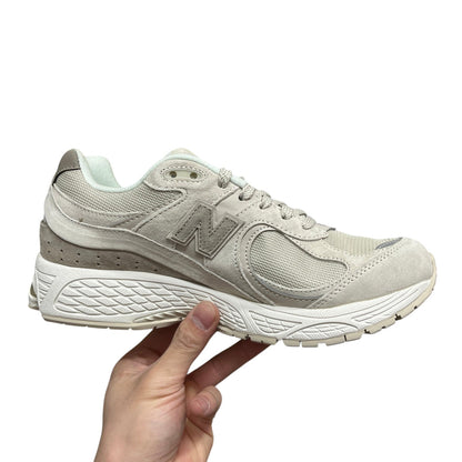Luxury Chef New Balance 2002R beige suede and mesh sneakers with N logo.