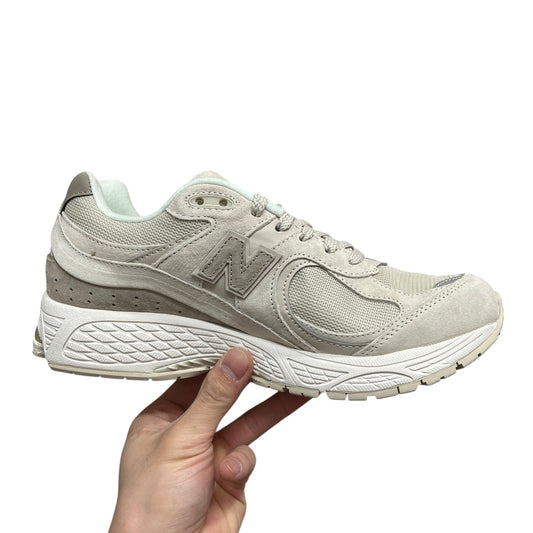 Luxury Chef New Balance 2002R beige suede and mesh sneakers with N logo.