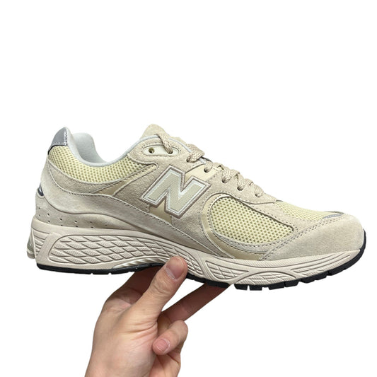 Luxury Chef New Balance 2002R beige suede and mesh sneakers with N logo.