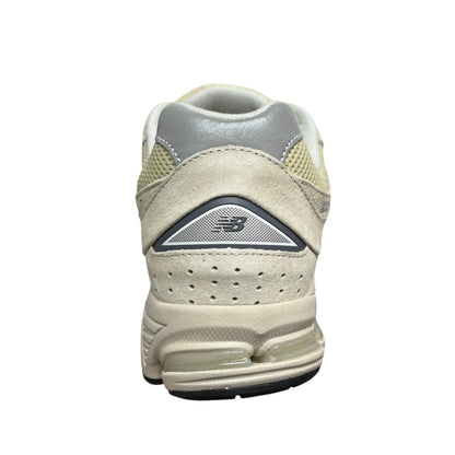 Luxury Chef New Balance 2002R beige suede and mesh sneakers with grey accents and visible cushioning.