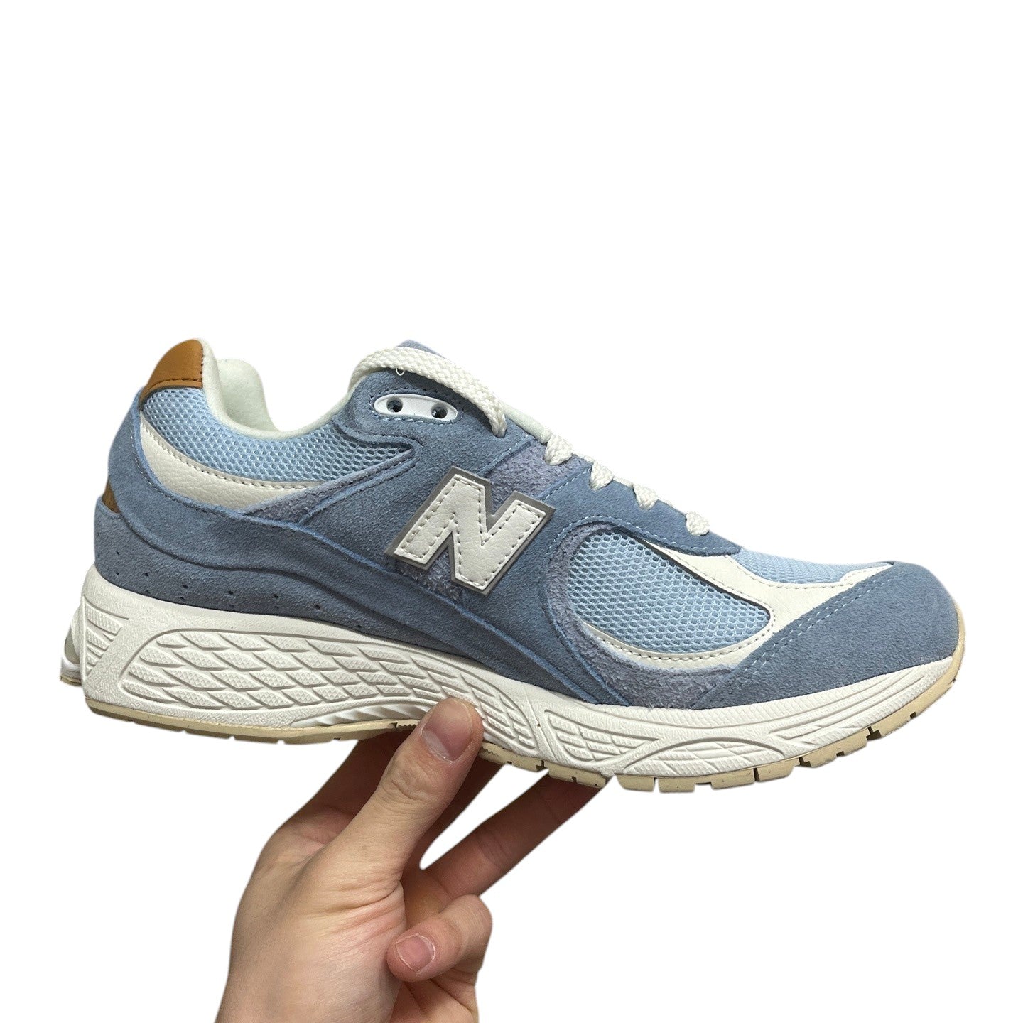Luxury Chef New Balance 2002R light blue suede and mesh sneakers with white N logo and tan heel accent.