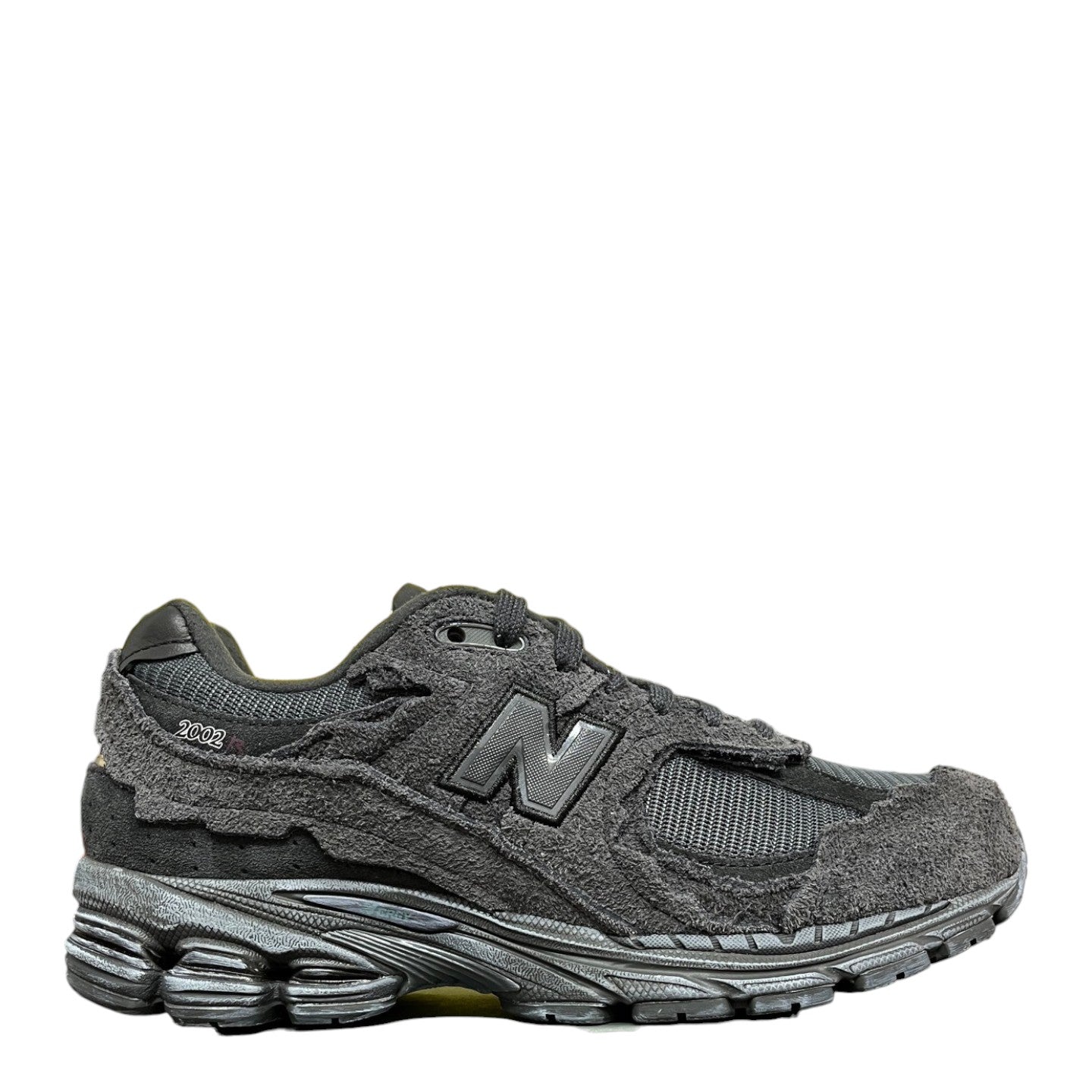 Luxury Chef New Balance 2002R dark grey suede and mesh sneakers with distressed detailing.