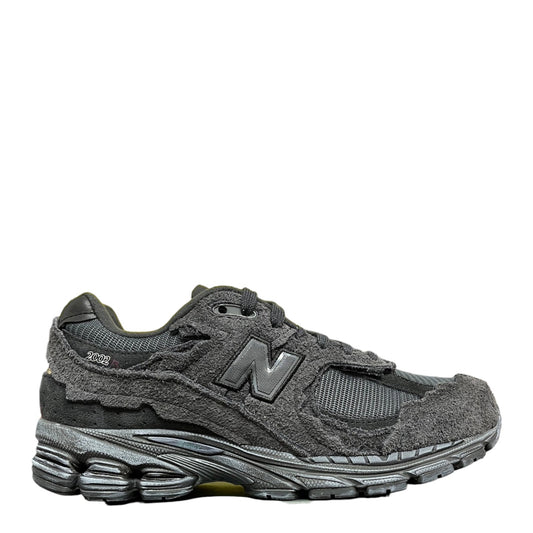 Luxury Chef New Balance 2002R dark grey suede and mesh sneakers with distressed detailing.