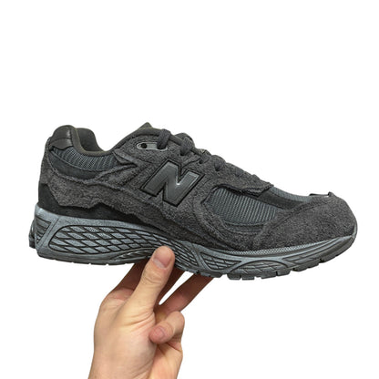 Luxury Chef New Balance 2002R dark grey suede and mesh sneakers with textured detailing.