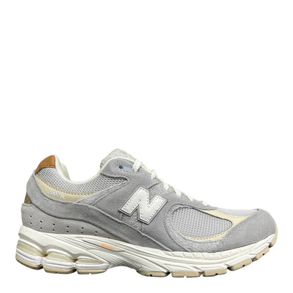 Luxury Chef New Balance 2002R light grey suede and mesh sneakers with white N logo and cream sole.