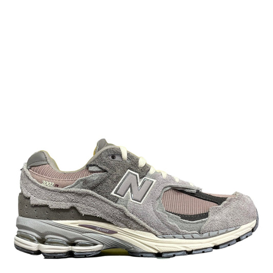 Luxury Chef New Balance 2002R grey suede and mesh sneakers with distressed detailing and N logo.