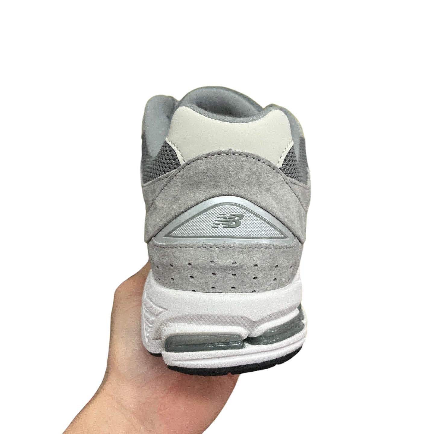 Luxury Chef New Balance 2002R grey suede and mesh sneakers with white midsole and grey accents.