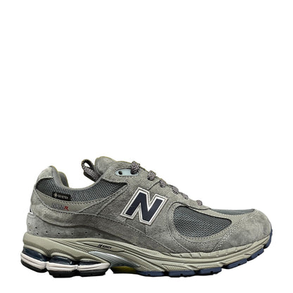 Luxury Chef New Balance 2002R grey suede and mesh sneakers with navy N logo and Gore-Tex. Lace-up athletic shoes.