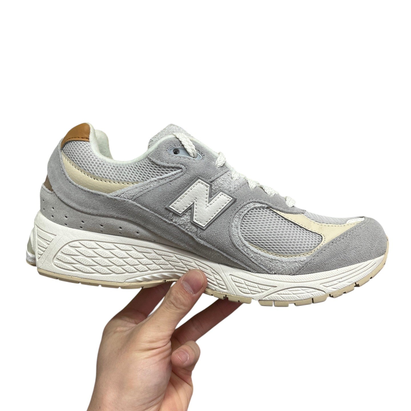 Luxury Chef New Balance 2002R light grey suede and mesh sneakers with white N logo and cream accents.
