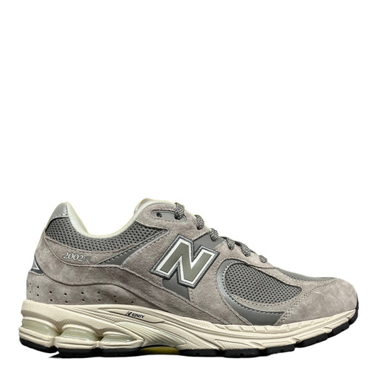 Luxury Chef New Balance 2002R grey suede and mesh sneakers with cream midsole and grey N logo.