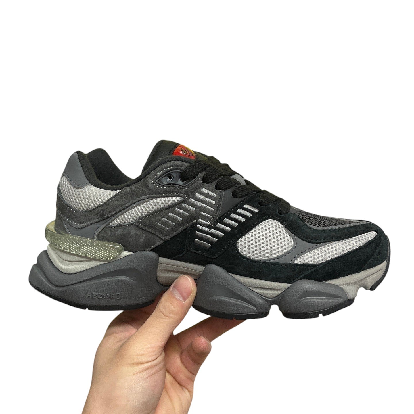 Luxury Chef New Balance 9060 sneakers in black and grey suede with mesh panels and a chunky sole.
