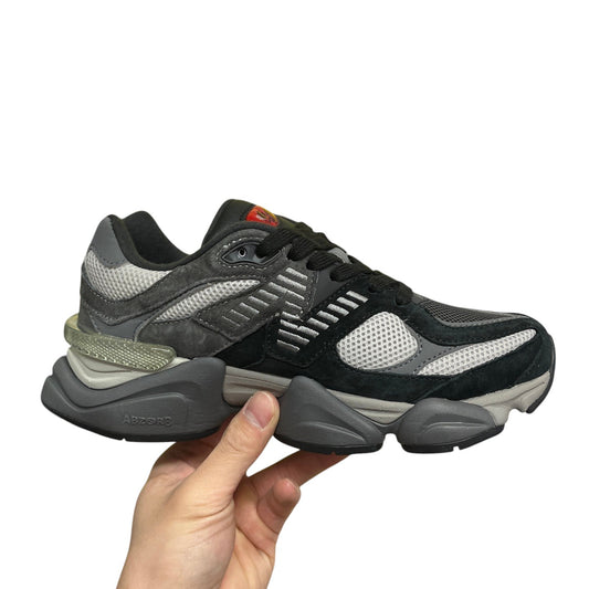Luxury Chef New Balance 9060 sneakers in black and grey suede with mesh panels and a chunky sole.