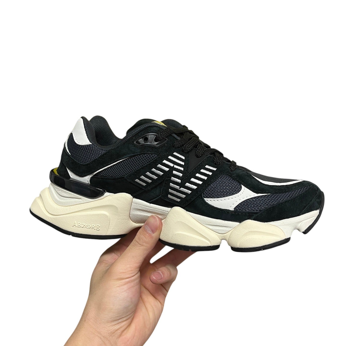 Luxury Chef New Balance 9060 black suede and mesh sneakers with white accents and cream sole.