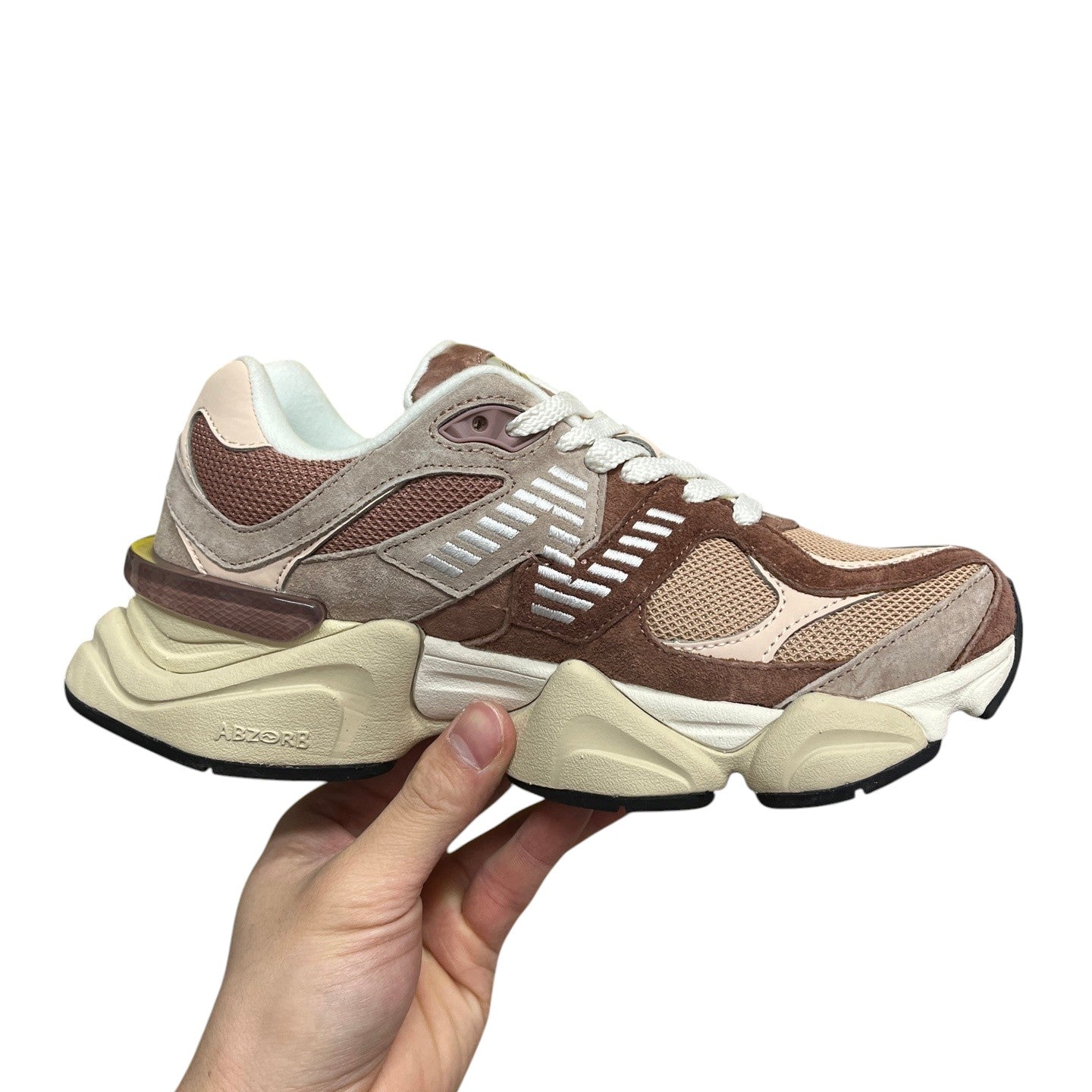 Luxury Chef New Balance 9060 sneakers in brown and pink suede with mesh panels and ABZORB sole.