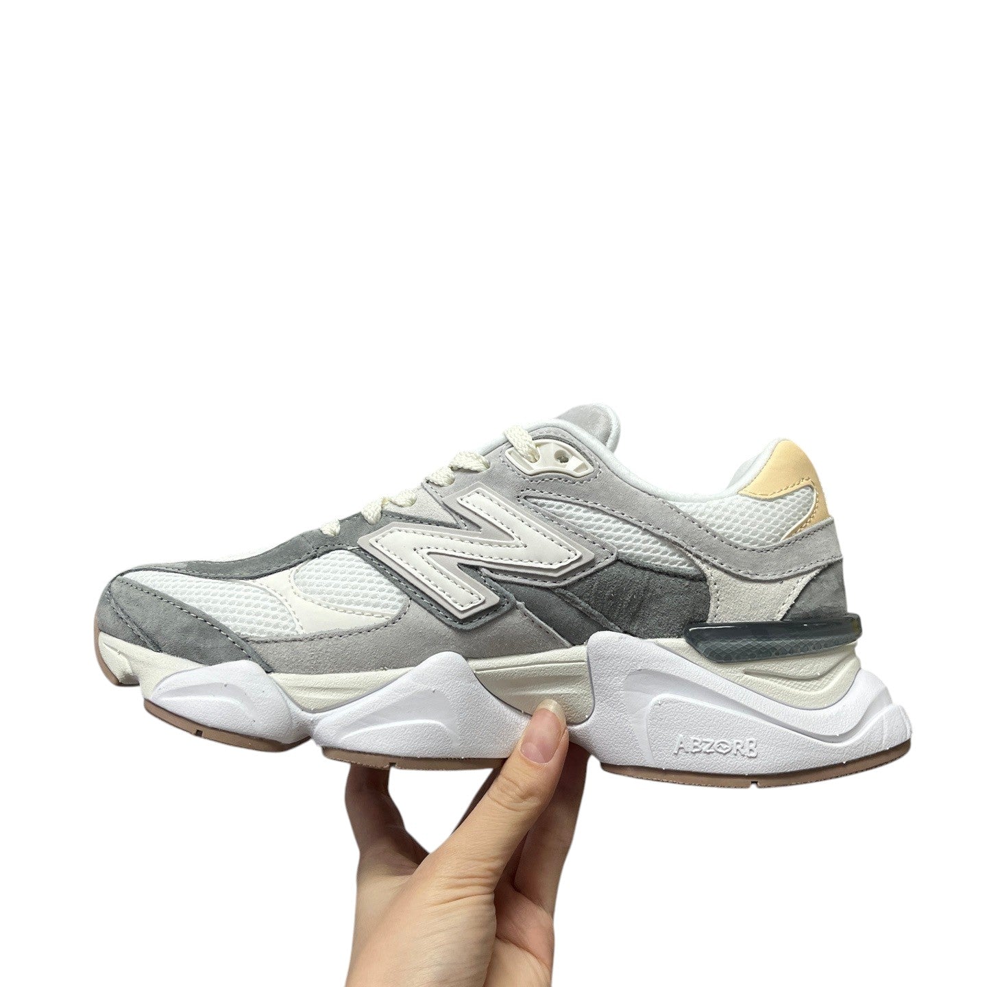Luxury Chef New Balance 9060 grey and white mesh and suede sneakers with a chunky white sole.