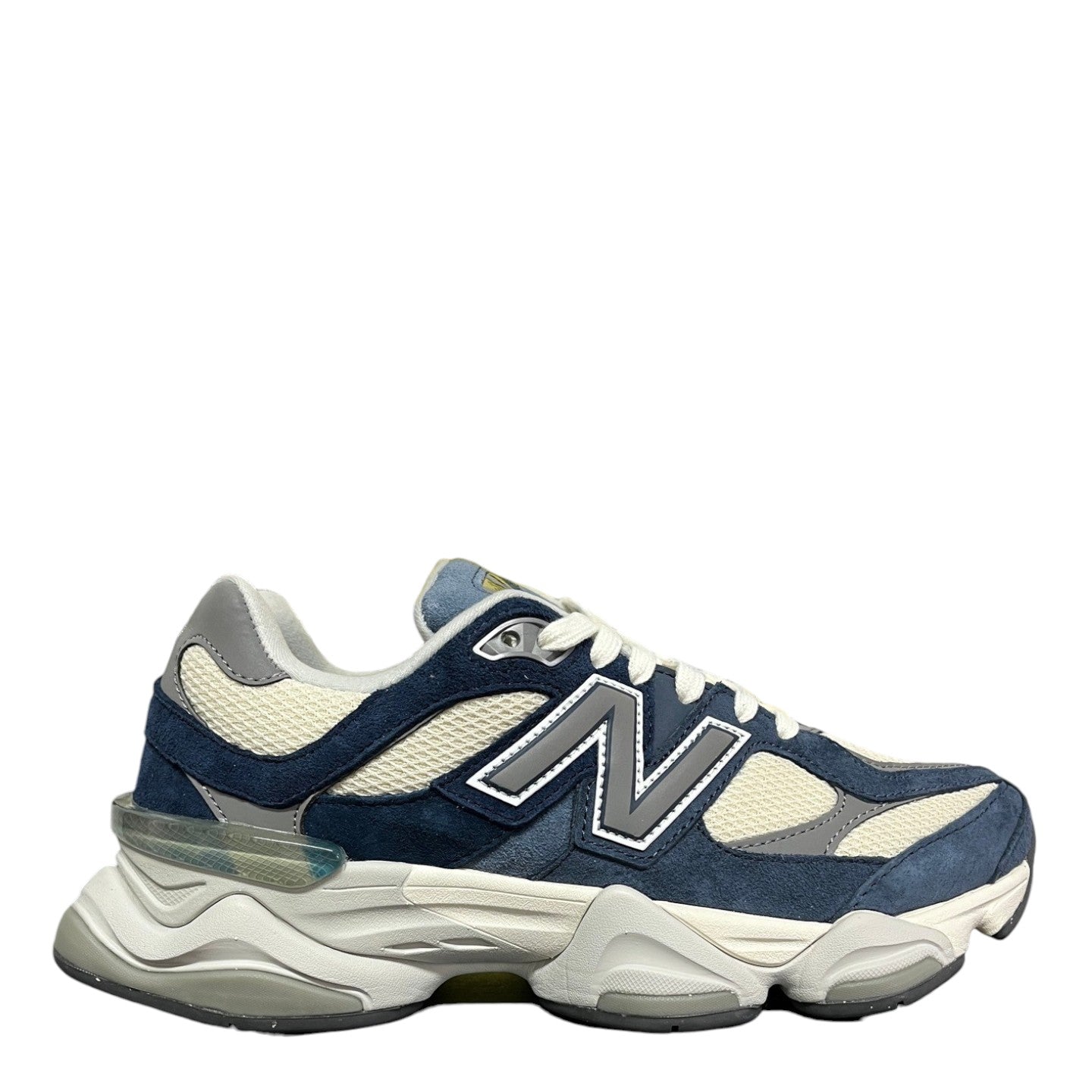 Luxury Chef New Balance 9060 sneakers in navy blue suede and cream mesh with grey accents and a chunky sole.