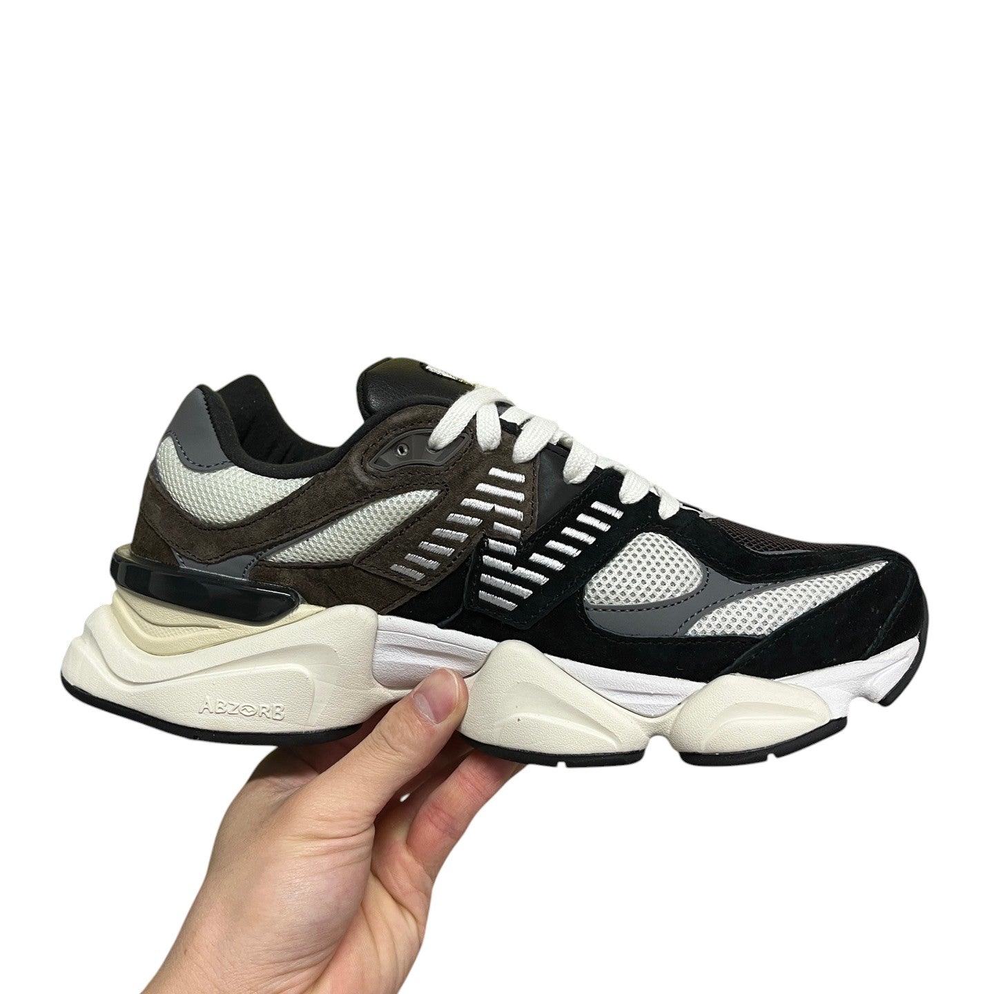 Luxury Chef New Balance 9060 sneakers with black, grey, and brown suede and mesh panels and a thick white ABZORB sole.