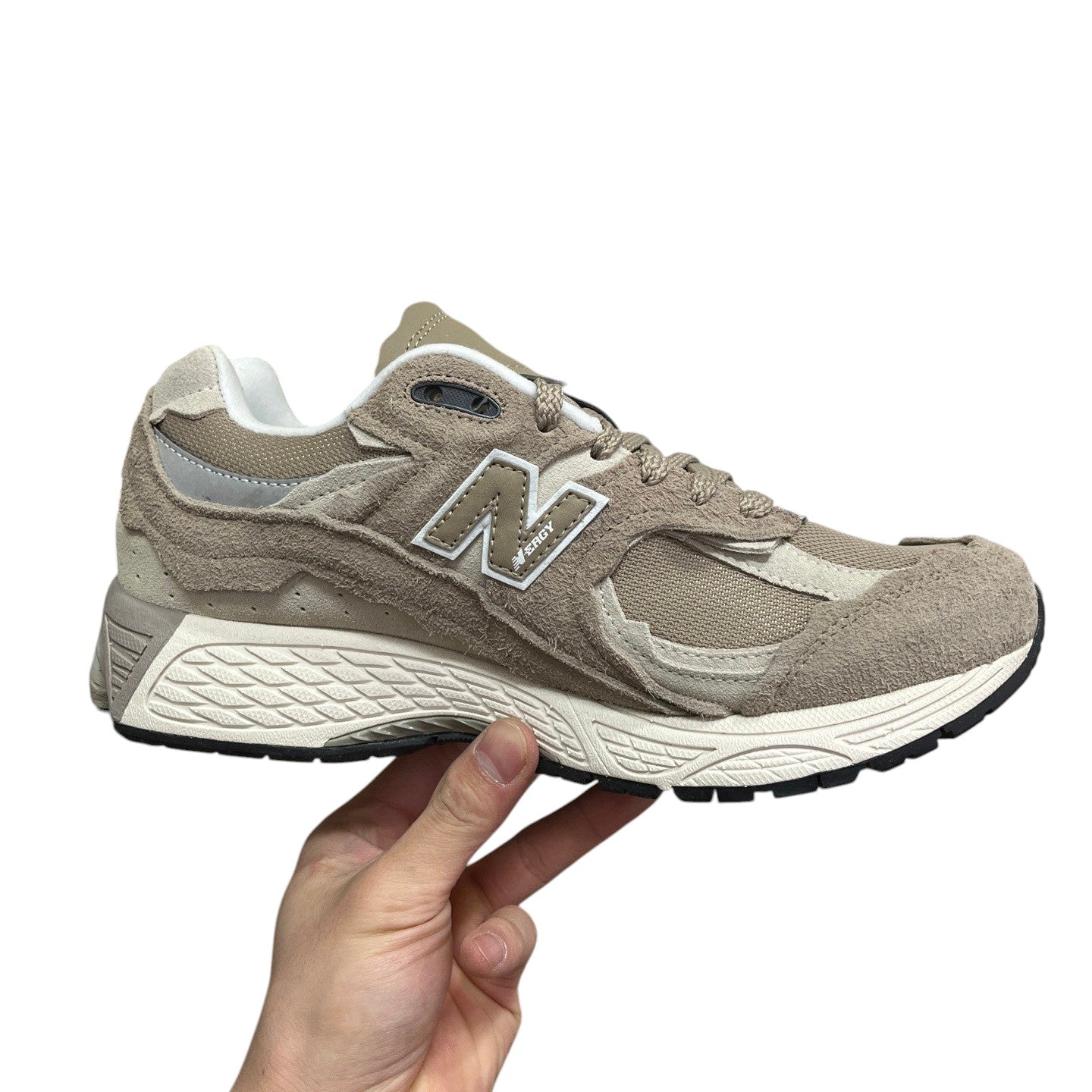 Luxury Chef New Balance 2002R beige suede and mesh sneakers with white sole and N logo.