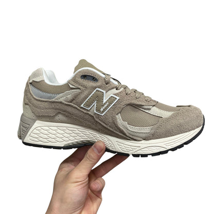 Luxury Chef New Balance 2002R beige suede and mesh sneakers with white sole and N logo.