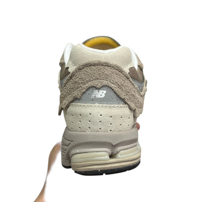 Luxury Chef NEW BALANCE 2002R beige suede and mesh sneakers with distressed detailing and N-ergy cushioning.