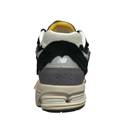 Luxury Chef New Balance 2002R sneakers in black, grey, and beige suede with a yellow interior.
