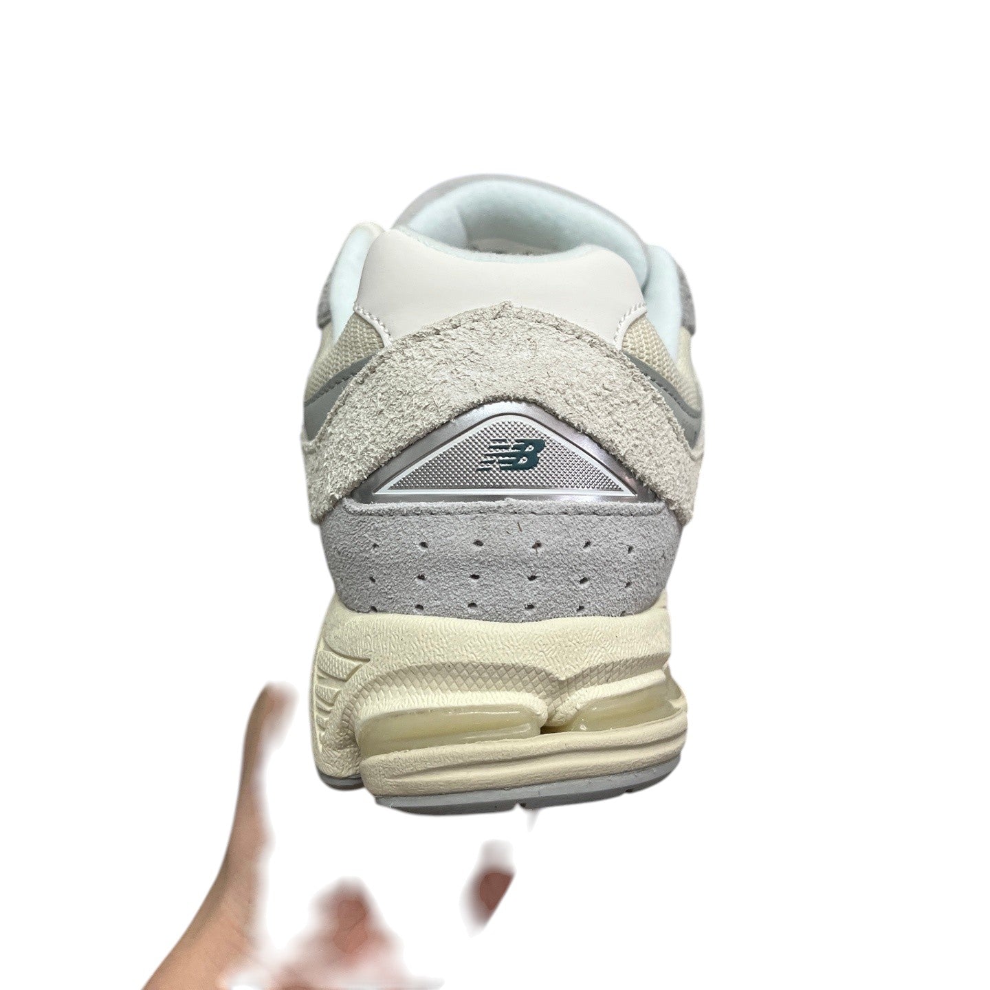 Luxury Chef New Balance 2002R sneakers in cream and grey suede with a cushioned sole and silver accents.