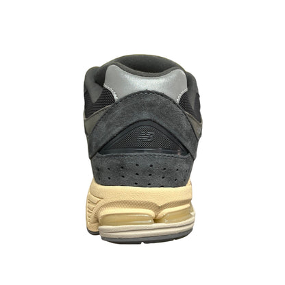 Luxury Chef New Balance 2002R dark grey suede and mesh sneakers with a cream sole.