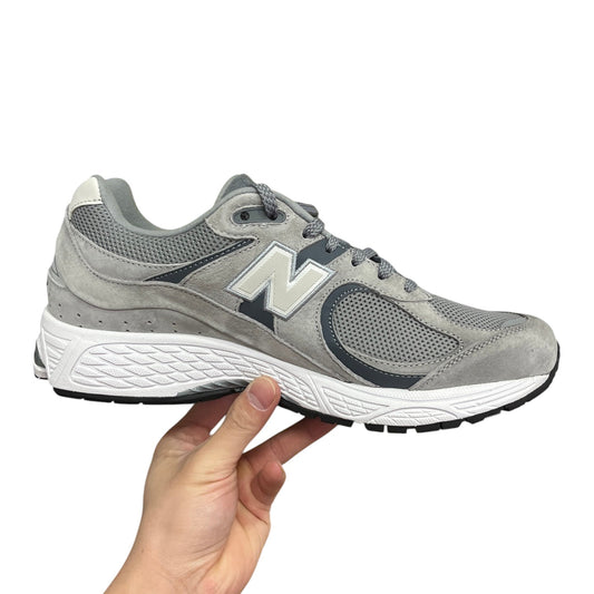 Luxury Chef New Balance 2002R grey suede and mesh sneakers with white sole and dark blue accents.