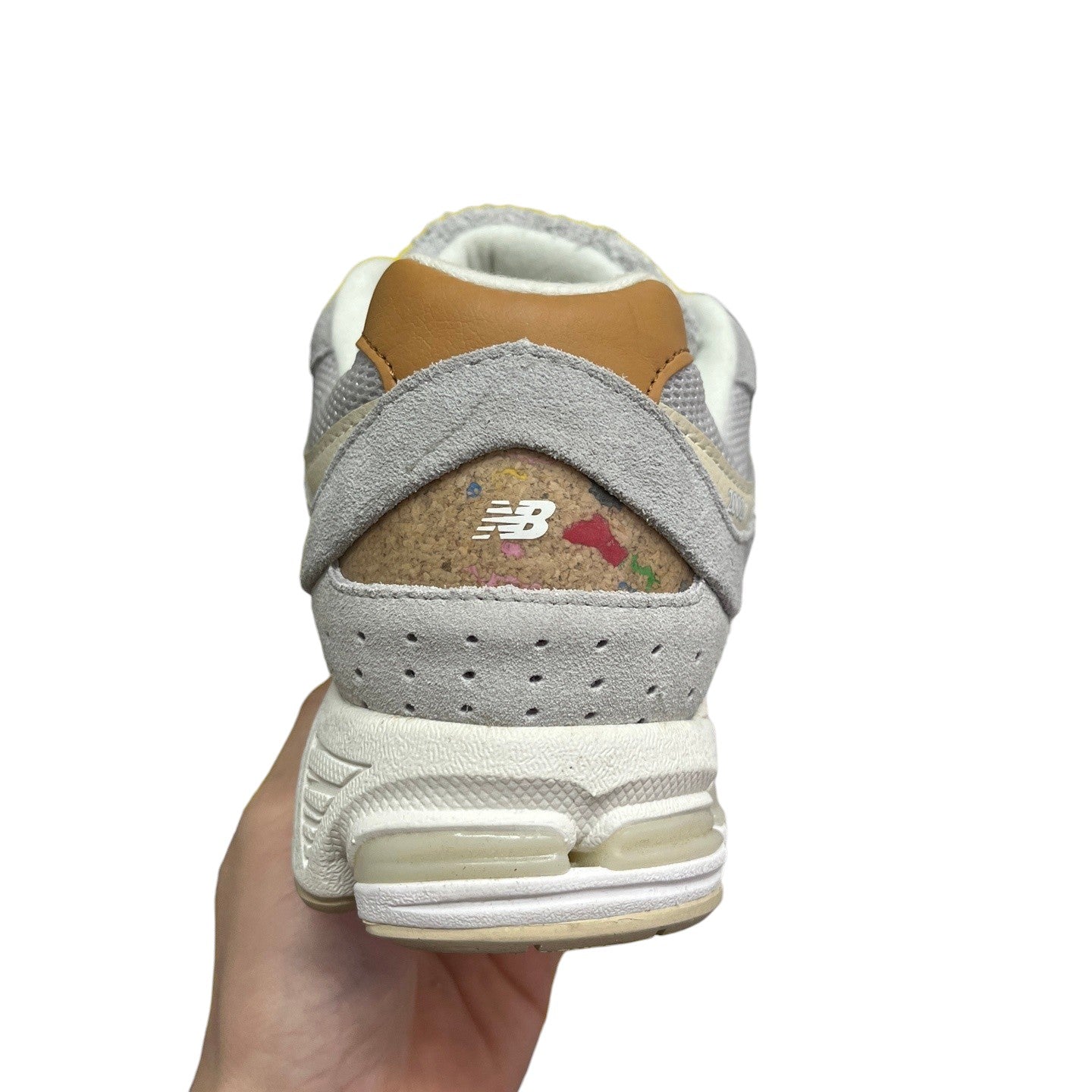 Luxury Chef NEW BALANCE 2002R grey suede sneakers with cork heel detail and tan accents.