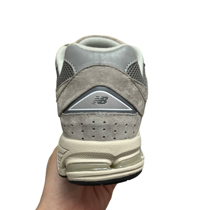 Luxury Chef New Balance 2002R grey suede and mesh sneakers with cream sole and clear heel cushioning.