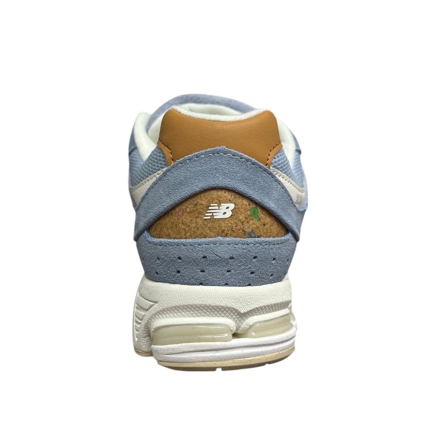 Luxury Chef New Balance 2002R light blue suede sneakers with tan heel accent and cork heel detail.
