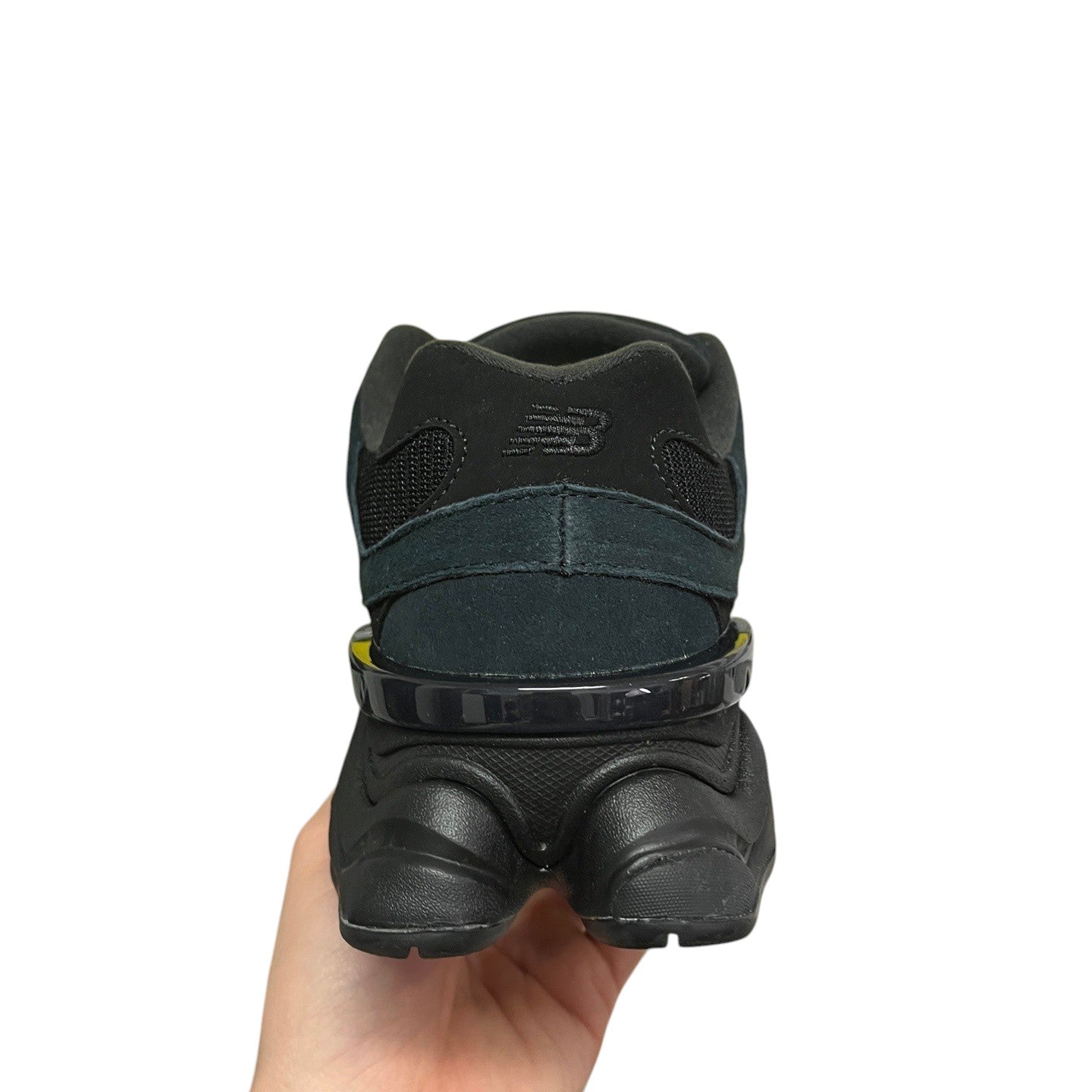 Luxury Chef New Balance 9060 black suede and mesh sneakers with a distinctive heel cage.