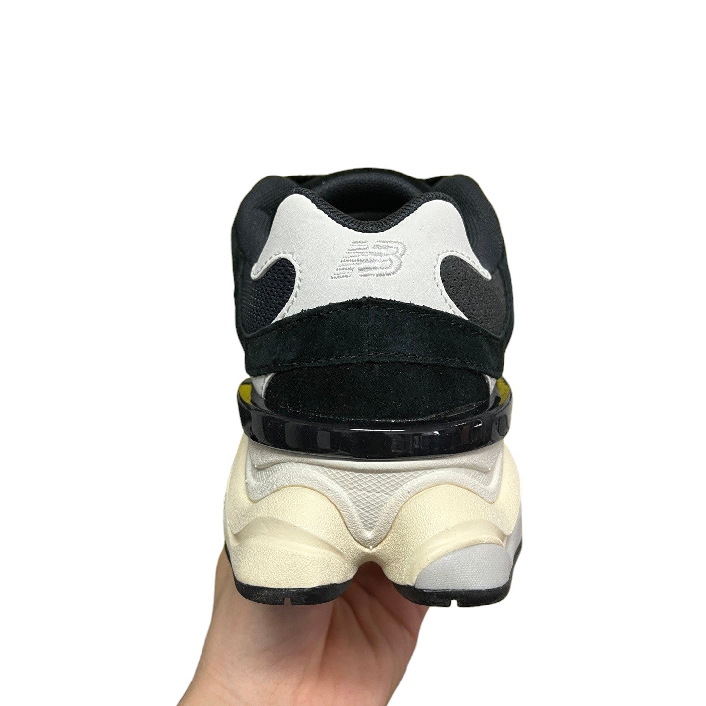 Luxury Chef New Balance 9060 black and white suede and mesh sneakers with cream sole.