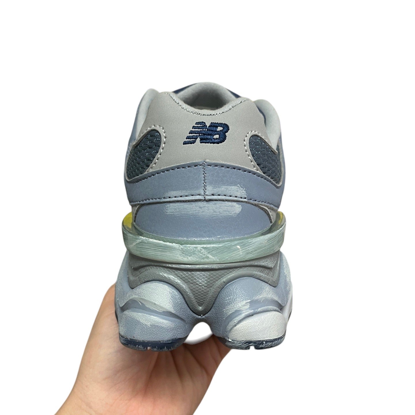 Luxury Chef New Balance 9060 sneakers in light blue and grey with mesh and suede details.