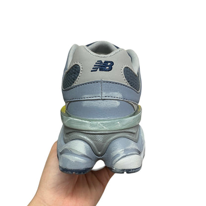 Luxury Chef New Balance 9060 sneakers in light blue and grey with mesh and suede details.