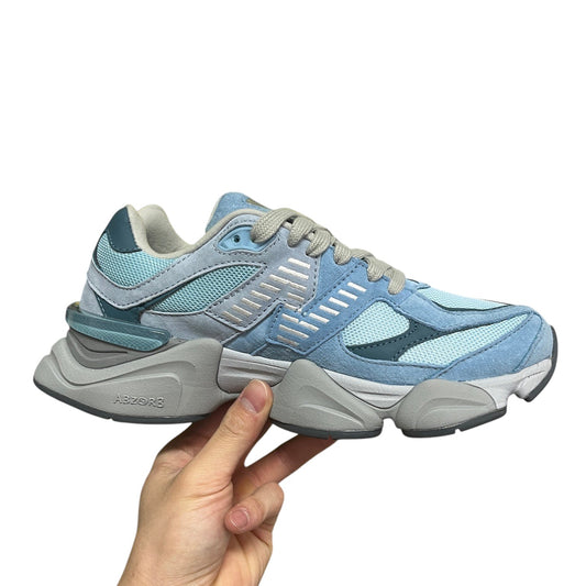 Luxury Chef New Balance 9060 sneakers in light blue suede and mesh with grey accents and ABZORB sole.