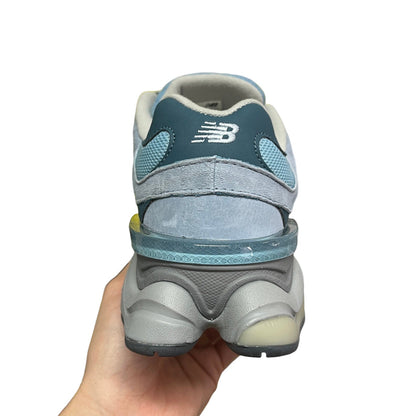 Luxury Chef New Balance 9060 light blue suede and mesh sneakers with grey accents and translucent heel detail.