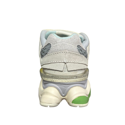 Luxury Chef NEW BALANCE 9060 light grey suede and mesh sneakers with light blue accents and green sole detail.