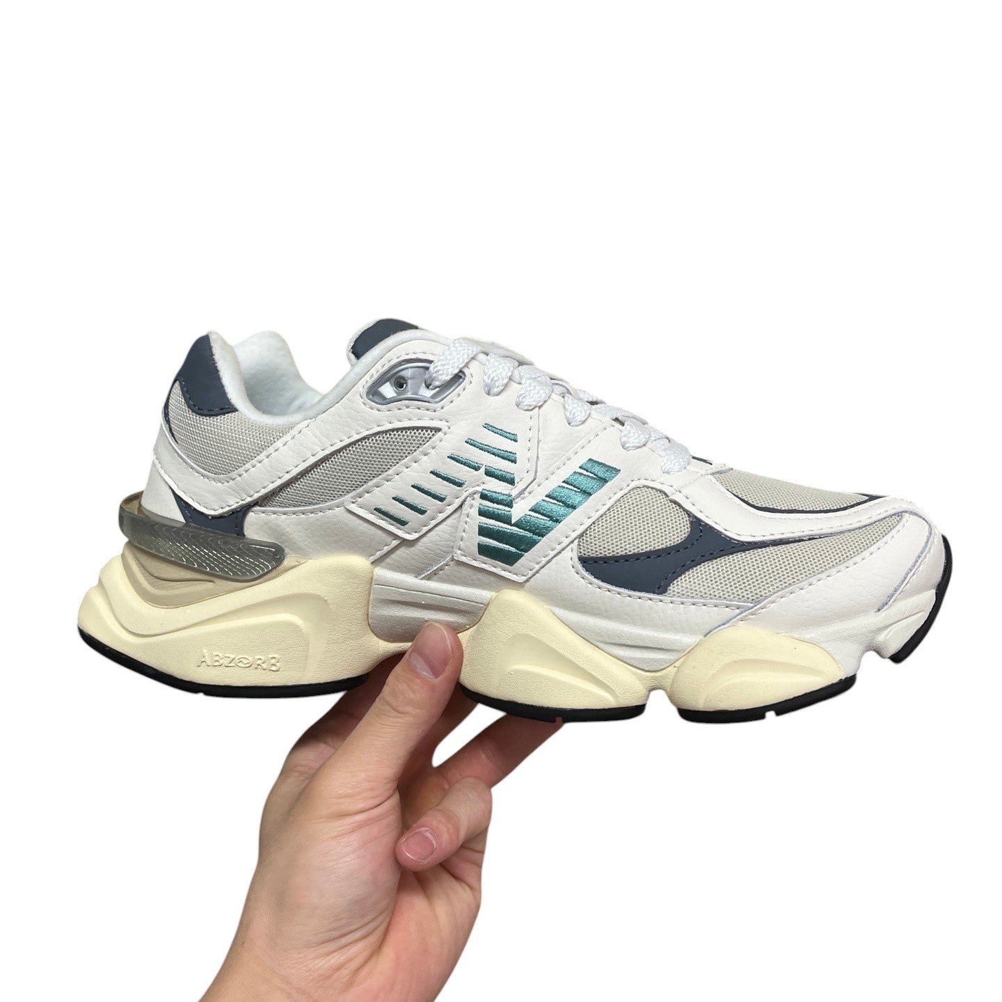Luxury Chef NEW BALANCE 9060 white and grey mesh sneakers with teal accents and chunky cream sole.