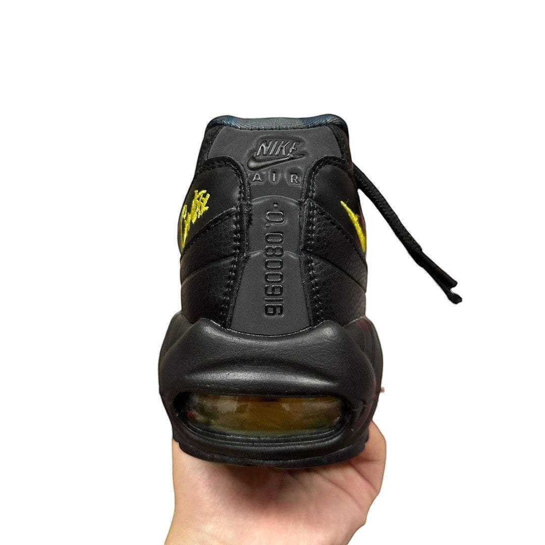 Luxury Chef Nike Air Max 95 Corteiz black leather sneakers with yellow accents and visible air cushioning.