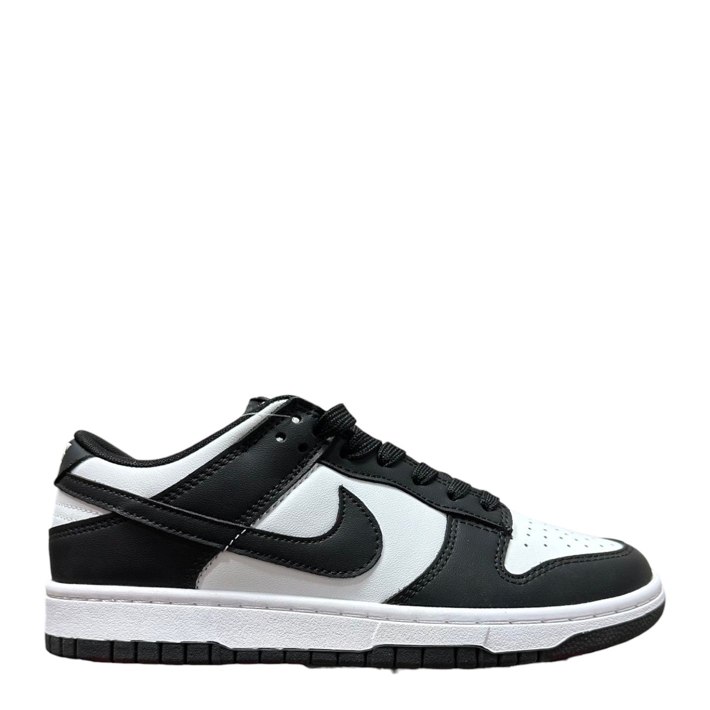 Luxury Chef Nike Dunk Low black and white leather sneakers with white sole and laces.