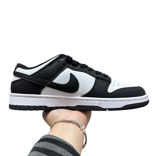 Luxury Chef Nike Dunk Low black and white leather sneakers with white sole and laces.