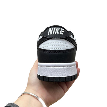 Luxury Chef Nike Dunk Low black and white leather sneakers with stitched Nike logo on heel tab.