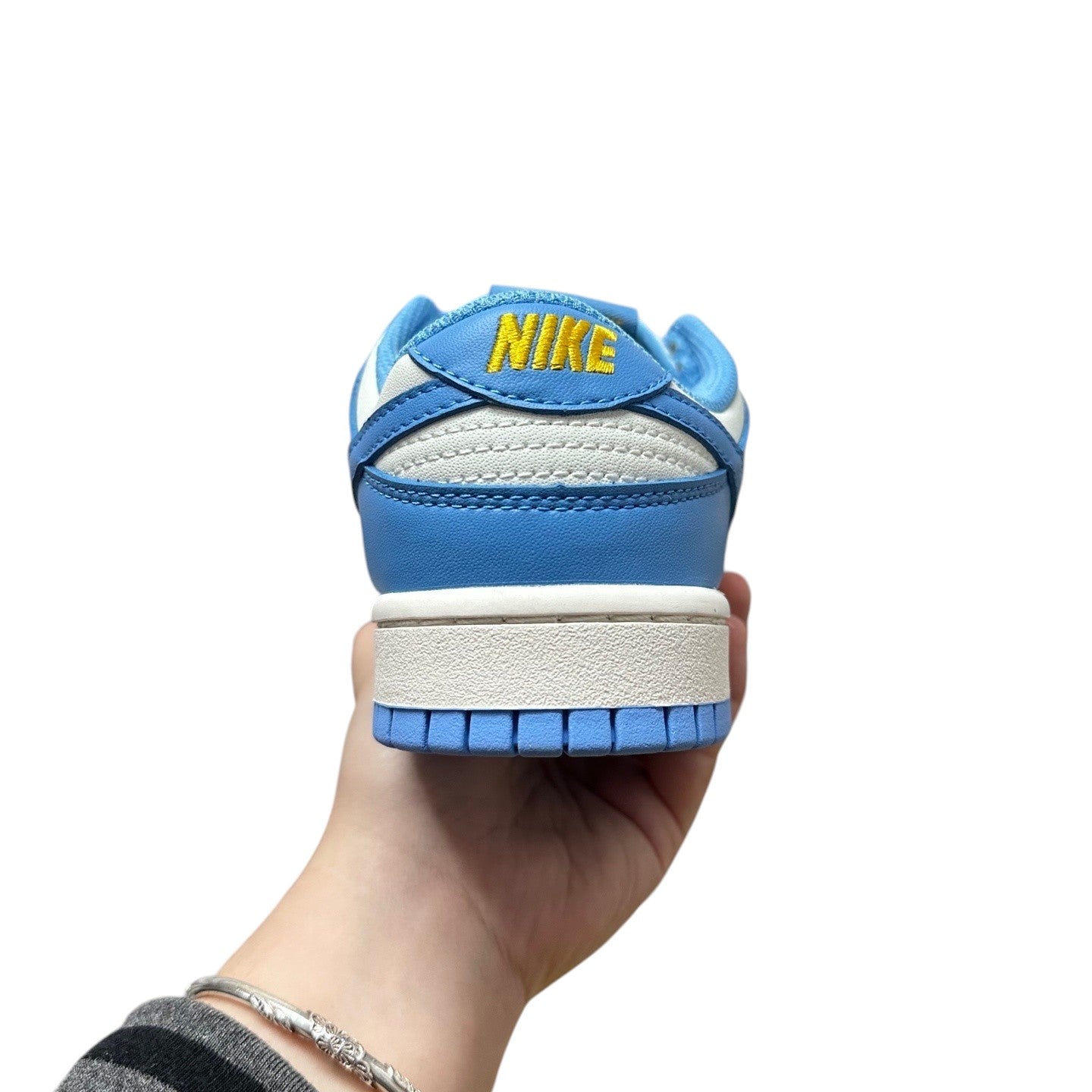 Luxury Chef Nike Dunk Low sneakers in blue and white leather with yellow Nike branding on heel.