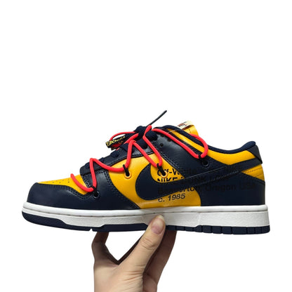 Luxury Chef Nike Dunk Low Off-White yellow and navy leather sneakers with red laces and white sole.