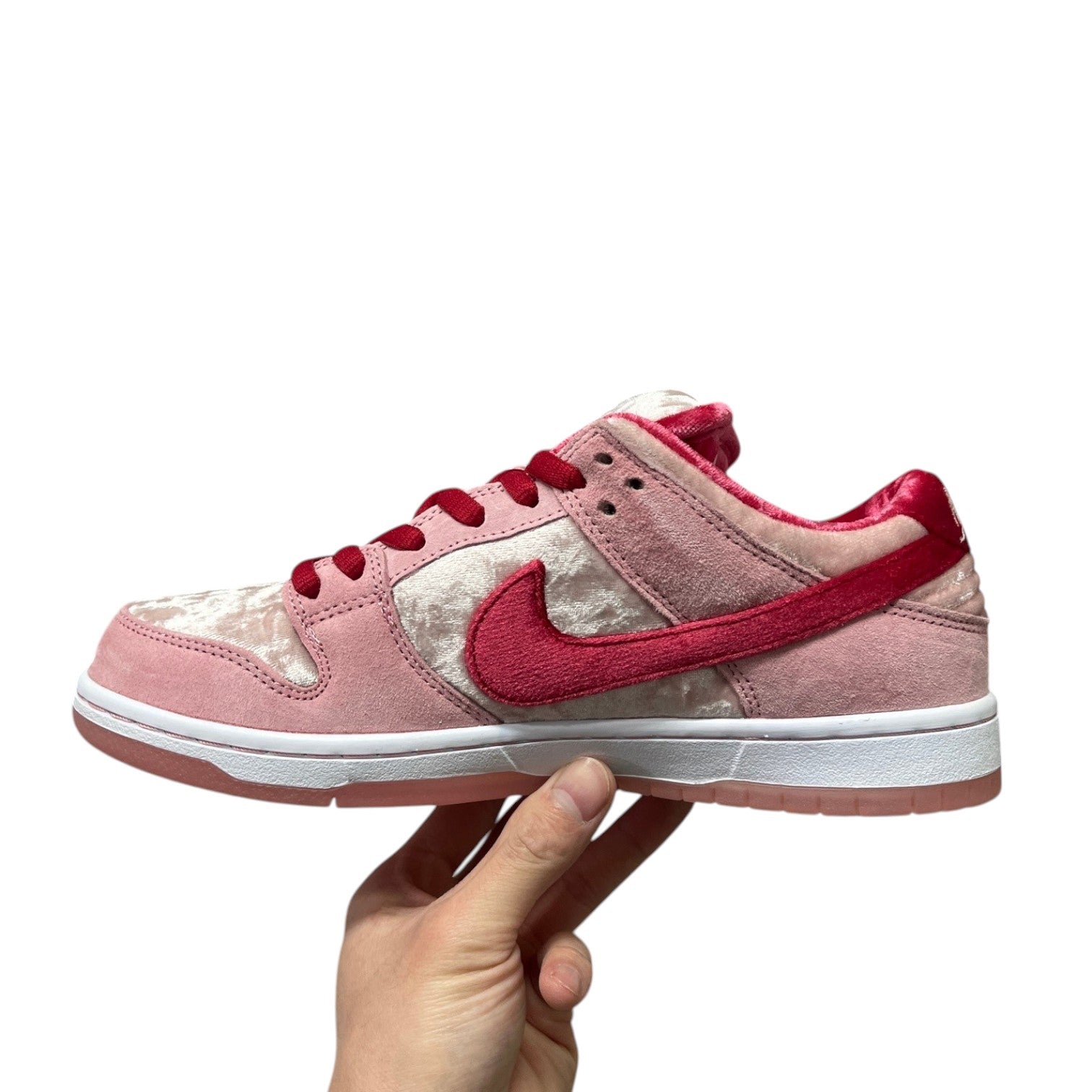 Luxury Chef Nike Dunk Low SB Strange Love sneakers in pink velvet and suede with red accents.