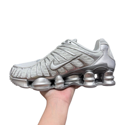 Luxury Chef Nike Shox sneakers in silver with mesh and metallic accents. Distinctive Shox cushioning.